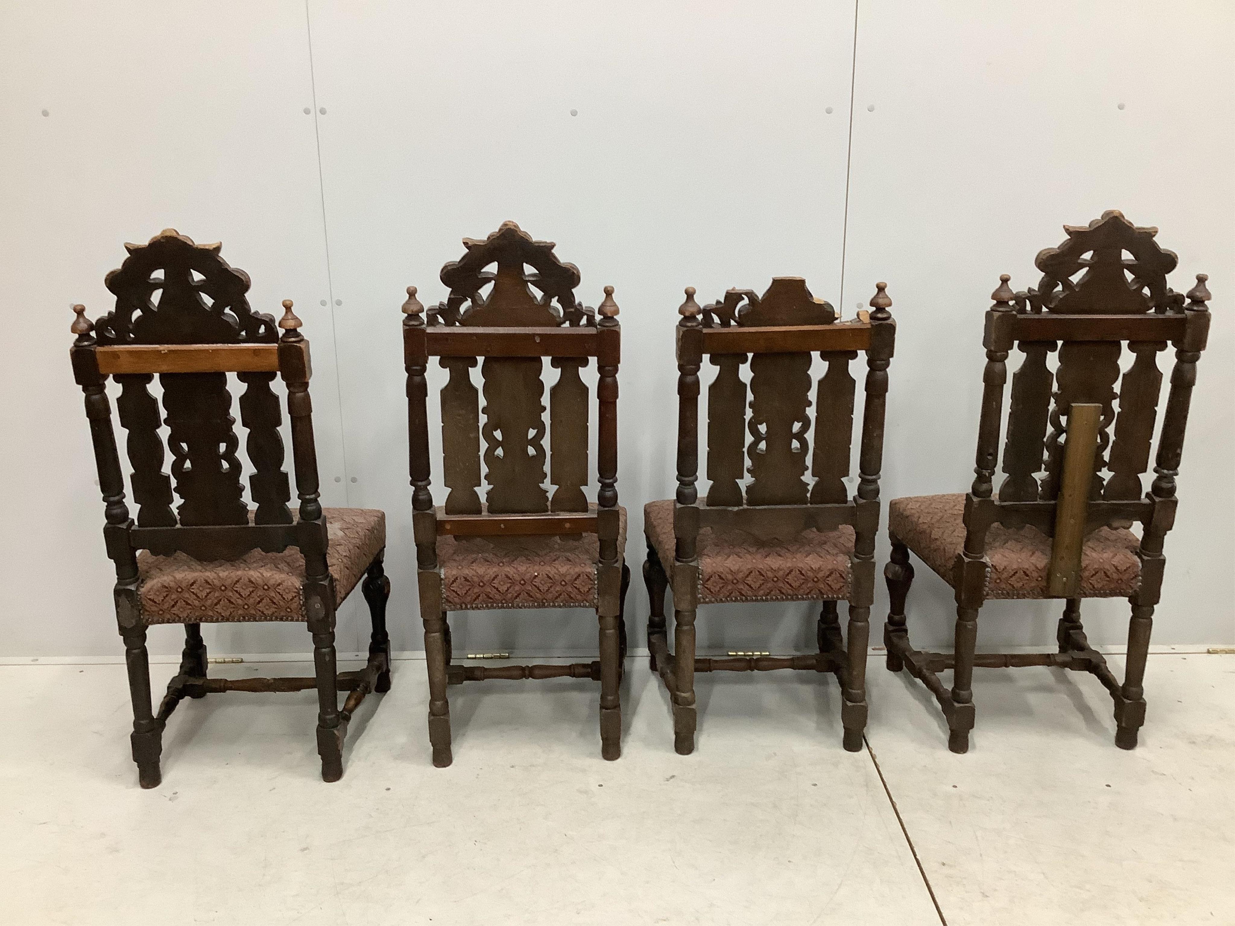 A set of thirteen carved Victorian oak dining chairs, one with arms. Condition - poor to fair